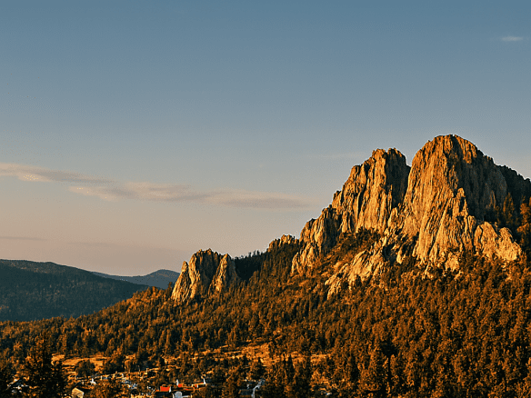 Scenic view of Hill City, South Dakota with rugged granite peaks and forested hills during golden hour