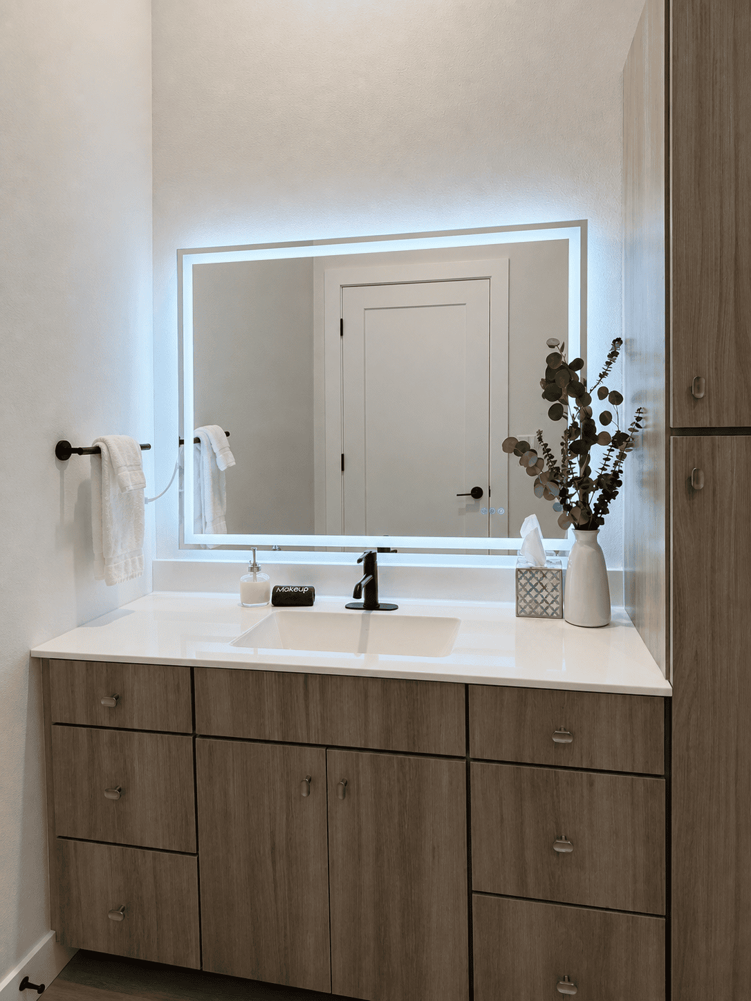 Primary bathroom vanity and mirror at The Waterline Okoboji
