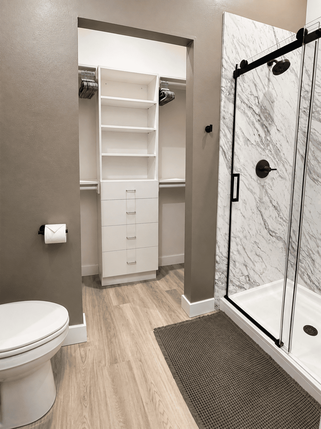 Primary bathroom shower and primary bedroom walk-in closet at The Waterline Okoboji